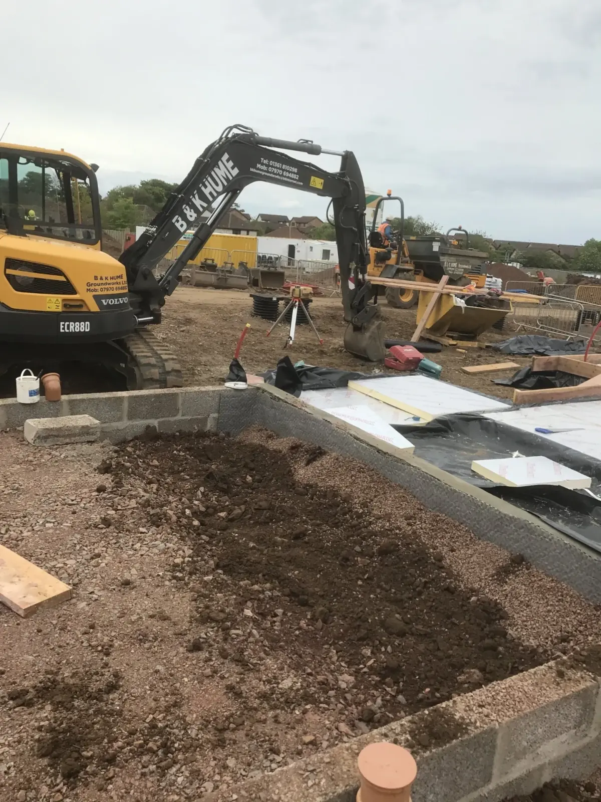 B&K Hume Volvo excavator working alongside new block-and-beam foundations on a Borders housing site
